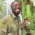 Kadeem Gilbert poses next to a large carnivorous plant.