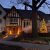 Exterior view of the W.K. Kellogg Manor House at dusk, decorated for the holidays.