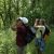 Two people peer through binoculars at the W.K. Kellogg Bird Sanctuary.