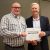 Brad Osborn stands with Dan Bollman, vice president for strategic infrastructure planning and facilities, holding a certificate for his Employee of the Quarter award.