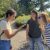 From left: Isabela Borges, Kara Haas, and Robin Waterman observe a monarch butterfly that landed on Isabela's palm.